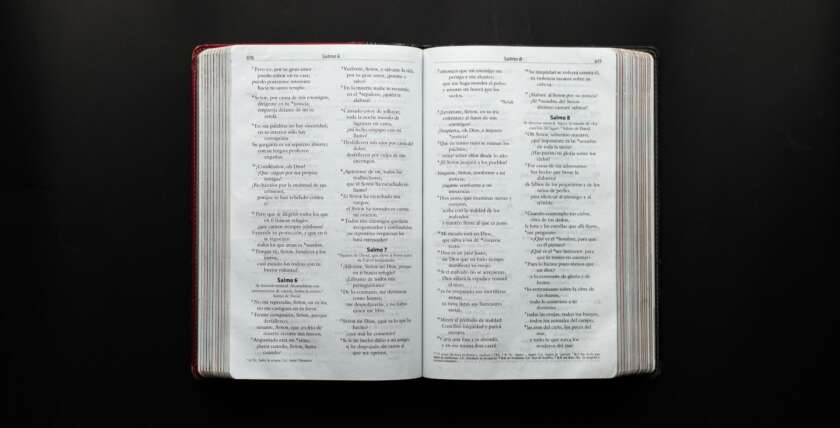 Open Bible displaying Psalms on a dark surface for study or inspiration.